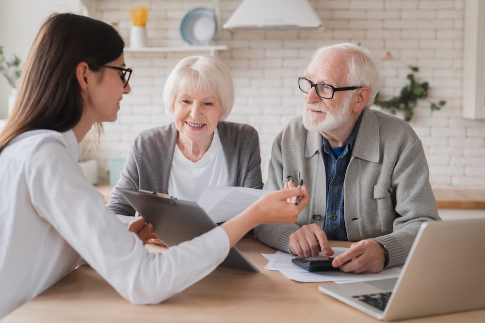 Woman talking with elderly couple | CRM metrics