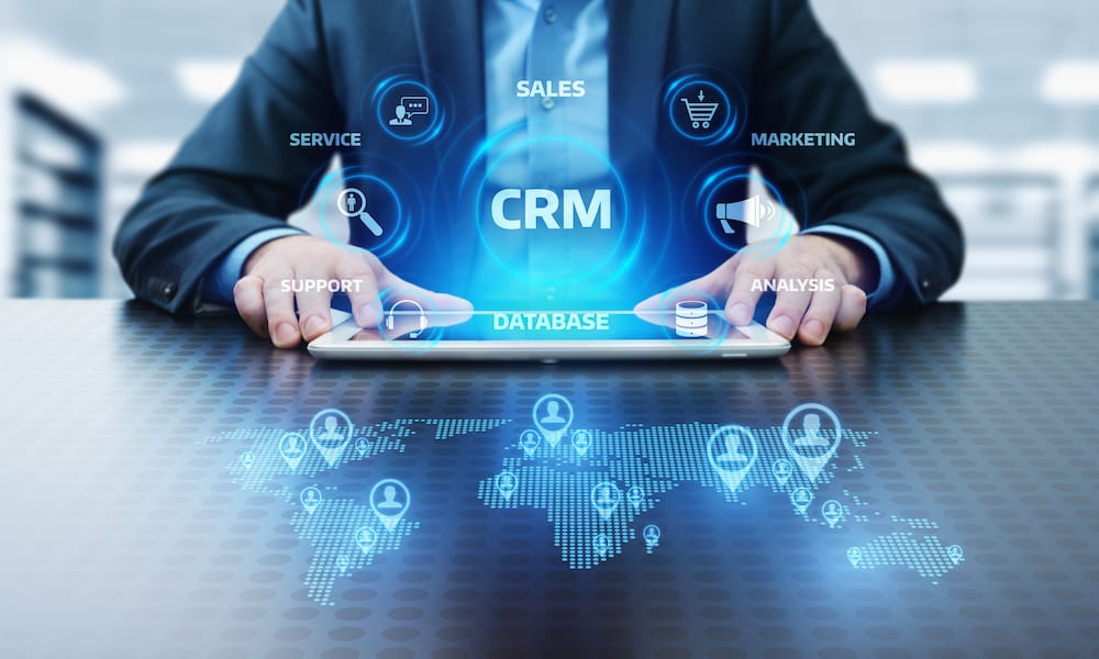 Man holding tablet with icons floating | Increase CRM adoption