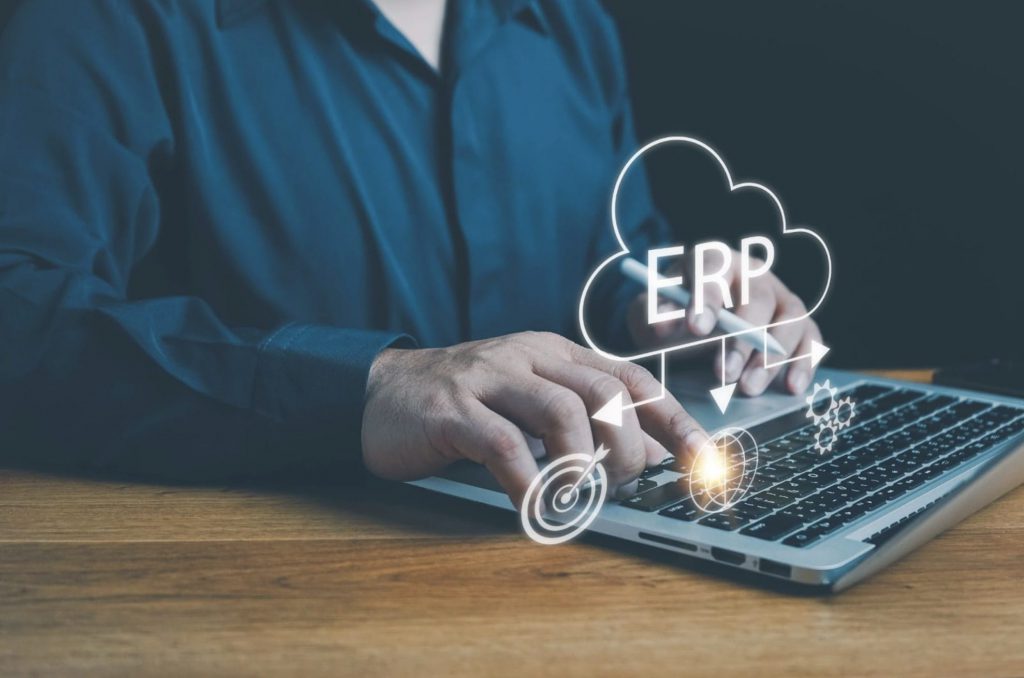 ERP icon above laptop | CRM vs. ERP